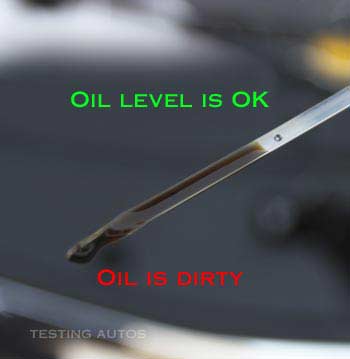 Dirty engine oil on the dipstick